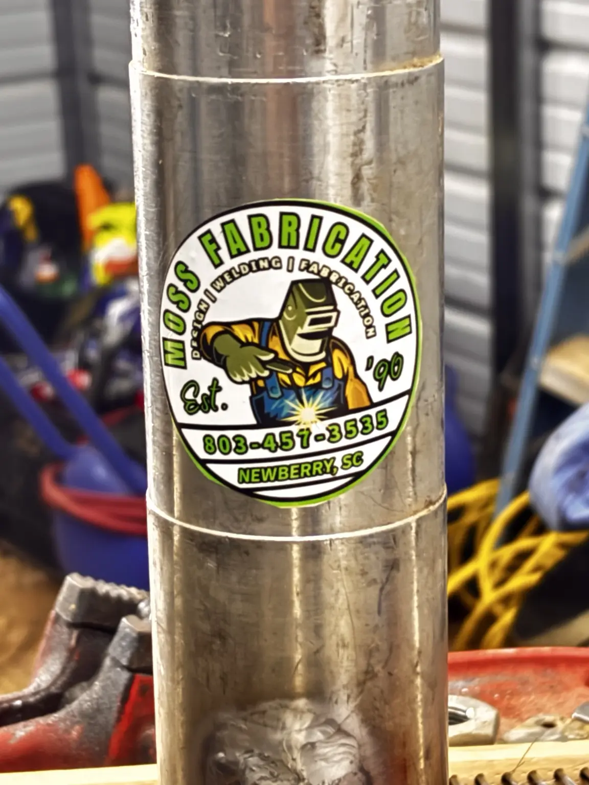 Fabricated aluminum cylindrical component marked Moss Fabrication